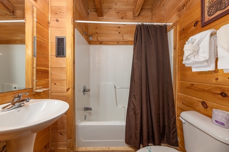 Bathroom with a tub and shower at Walkin' to Gatlinburg, a 2 bedroom cabin rental located in Gatlinburg