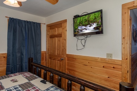 TV in a bedroom at Mountain Music, a 5 bedroom cabin rental located in Pigeon Forge