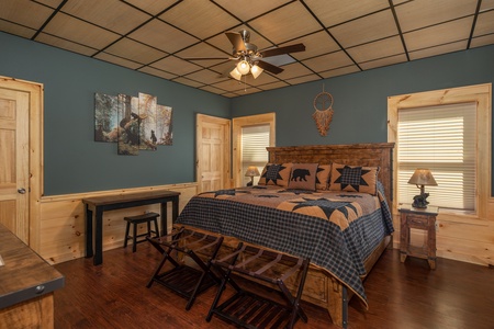 Bedroom with a queen bed, two night stands, two lamps, and a desk at Gar Bear's Hideaway, a 3 bedroom cabin rental located in Pigeon Forge