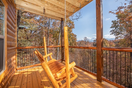 Porch swing on a covered deck at Pinot Splash, a 4 bedroom cabin rental located in Gatlinburg