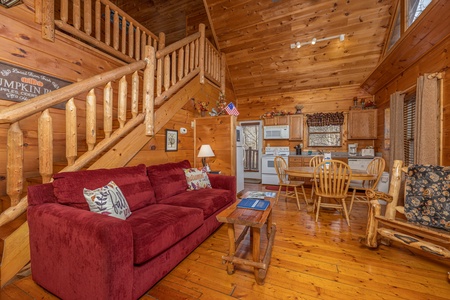 Sofa and chair in a living room at Fallin' in Love, a 1 bedroom cabin rental located in Gatlinburg