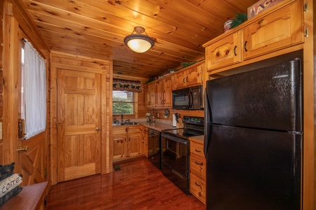 Kitchen with black appliances at 1 Above the Smokies, a 2 bedroom cabin rental located in Pigeon Forge