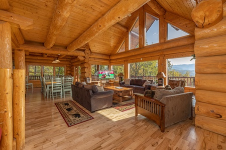 Vaulted living room with large windows at Grizzly's Den, a 5 bedroom cabin rental located in Gatlinburg