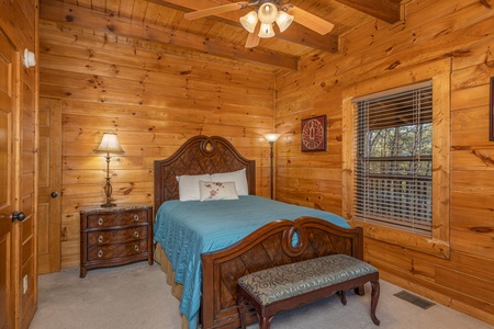 Bedroom with a dresser and bench at King of the Mountain, a 3 bedroom cabin rental located in Pigeon Forge