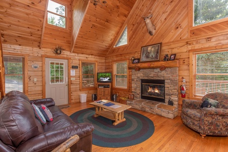Fireplace and television in the living room at Cabin in the Clouds, a 3-bedroom cabin rental located in Pigeon Forge