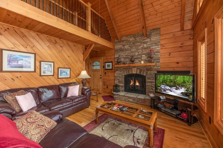 Fireplace and TV in the living room at Mountain Lake Getaway, a 3 bedroom cabin rental located at Douglas Lake