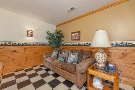 Sofa in the game room at Cub's Crossing, a 3 bedroom cabin rental located in Gatlinburg