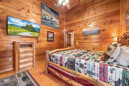 TV, Loveseat, dresser, and TV in a bedroom at Moonshine Memories, a 2 bedroom cabin rental located in Gatlinburg