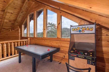 Air hockey table and a PacMan game at Mountain View Meadows, a 3 bedroom cabin rental located in Pigeon Forge