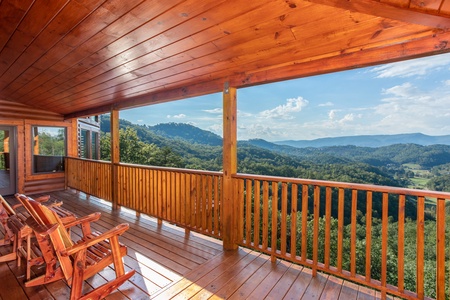 Rocking chairs on the deck overlooking the mountains at Four Seasons Palace, a 5-bedroom cabin rental located in Pigeon Forge
