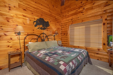 King bed and two night stands in a bedroom at Gone Fishin', a 2-bedroom cabin rental located in Pigeon Forge