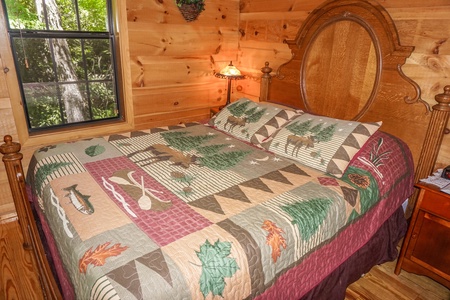 Queen sized bed in bedroom at Seclusion, a 1 bedroom cabin rental located in Gatlinburg