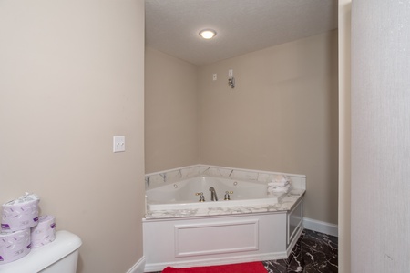 A corner jacuzzi tub in a bathroom at Into the Woods, a 3 bedroom cabin rental located in Pigeon Forge