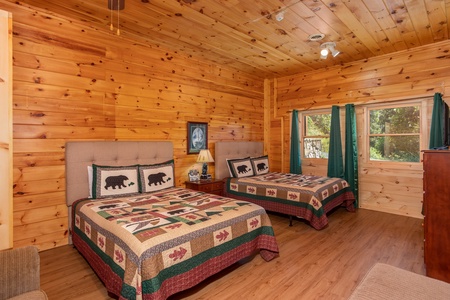 Two queen beds with tufted headboards at Cabin Fever, a 4-bedroom cabin rental located in Pigeon Forge