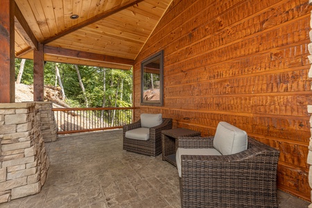 Two chairs and a table outdoors at Black Bears & Biscuits Lodge, a 6 bedroom cabin rental located in Pigeon Forge