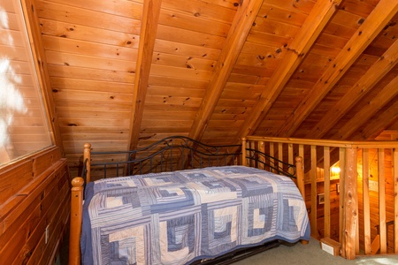 Twin bed in the loft at Hawk's Nest, a 1 bedroom cabin rental located in Pigeon Forge