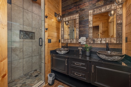 Bathroom with double sinks and large shower at Black Bears & Biscuits Lodge, a 6 bedroom cabin rental located in Pigeon Forge