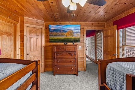 Twin bunk beds and en suite bath at Better View, a 4 bedroom cabin rental located in Pigeon Forge