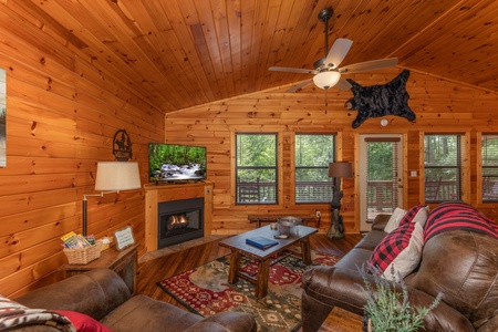 Vaulted living room with fireplace and TV at Hawk's Heart Lodge, a 3 bedroom cabin rental located in Pigeon Forge