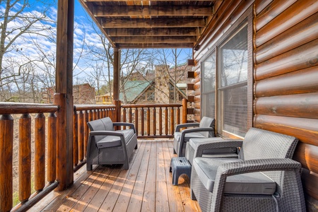 Covered deck and seating at Natural Wonder, a 4 bedroom cabin rental located in Gatlinburg