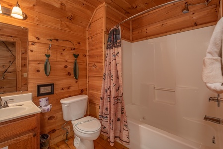 Bathroom with a tub and shower at Logan's Smoky Den, a 2 bedroom cabin rental located in Pigeon Forge