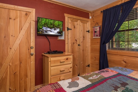 Dresser and TV in a bedroom at Patriot Pointe, a 5 bedroom cabin rental located in Pigeon Forge