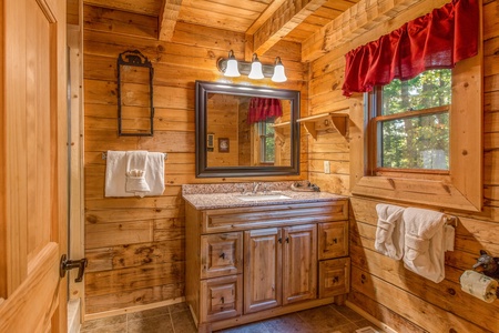Vanity in the bathroom at Cupid's Crossing, a 1 bedroom cabin rental located in Pigeon Forge