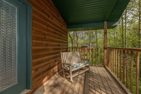 Rocking chair on a deck at A Moment in Time, a 2 bedroom cabin rental located in Pigeon Forge