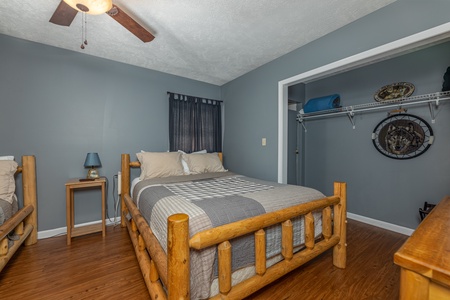 Bedroom with two beds, dresser, table, and lamp at Wildlife Retreat, a 3 bedroom cabin rental located in Pigeon Forge