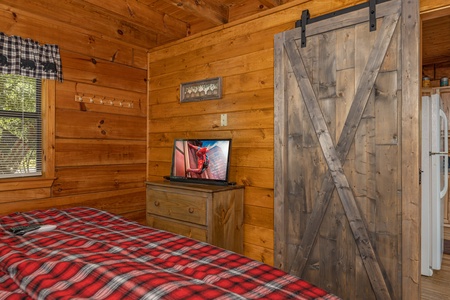 Dresser and TV in a bedroom at Walkin' To Gatlinburg, a 2 bedroom cabin rental located in Gatlinburg