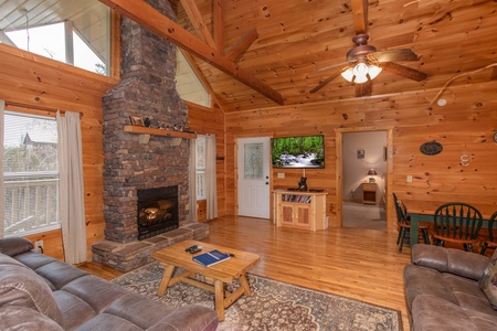 Living room with stacked stone fireplace and television at Bearly in the Mountains, a 5-bedroom cabin rental located in Pigeon Forge