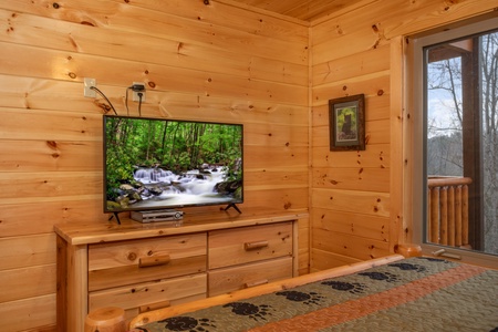 Dresser and TV in a bedroom at Happy Bear's Hideaway, a 2 bedroom cabin rental located in Gatlinburg