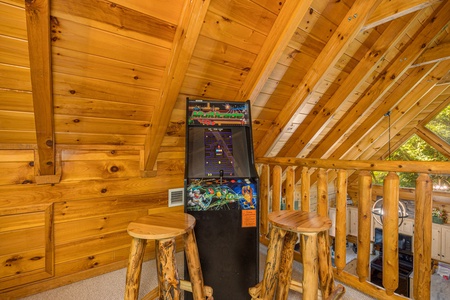 Arcade in the loft at Bear Feet Retreat, a 1 bedroom cabin rental located in pigeon forge