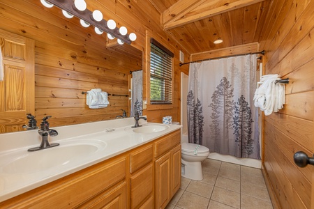 Master bath with shower and bathtub at Loving Every Minute, a 5 bedroom cabin rental located in Pigeon Forge