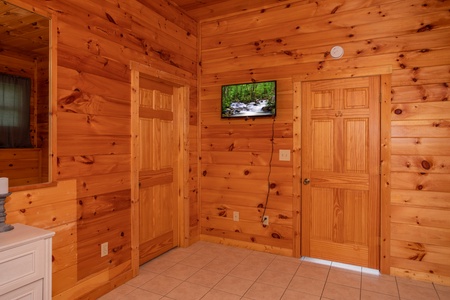 Wall mounted tv in a bedroom at Cabin Fever, a 4-bedroom cabin rental located in Pigeon Forge