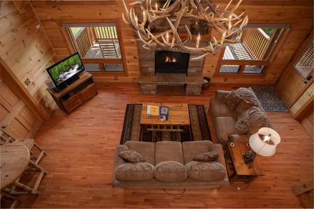 Living room and antler chandelier from above at Cedar Creeks, a 2-bedroom cabin rental located near Douglas Lake