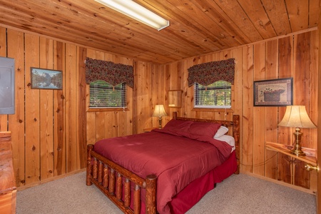 A queen-sized log bed in the second bedroom at Apple View, a 2 bedroom cabin rental located in Pigeon Forge