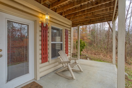Downstairs porch with a log rocker at Bearly in the Mountains, a 5-bedroom cabin rental located in Pigeon Forge