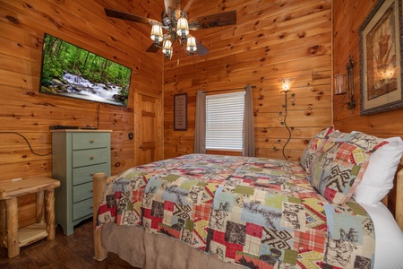 Dresser, TV, and end table in a bedroom at Southern Charm, a 2 bedroom cabin rental located in Pigeon Forge