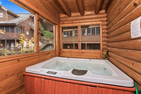 Hot tub on a covered deck at Starry Starry Night #725, a 2 bedroom cabin rental located in Pigeon Forge