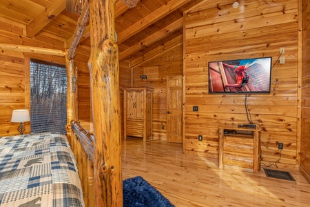 TV and night stand in a bedroom at A Bear on the Ridge, a 2 bedroom cabin rental located in Pigeon Forge
