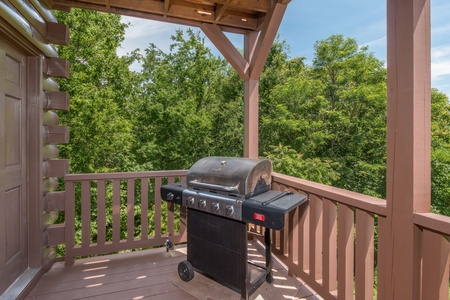 Grill on a covered deck at Moose Lodge, a 4 bedroom cabin rental located in Sevierville