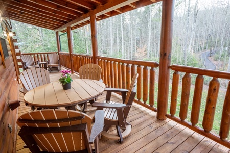 Table and chairs on deck at 3 Crazy Cubs, a 5 bedroom cabin rental located in pigeon forge