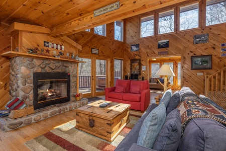 Living room with a fireplace and TV at Hatcher Mountain Retreat a 2 bedroom cabin rental located in Pigeon Forge