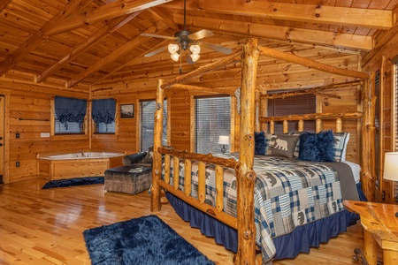 Loft bedroom with a four post bed and jacuzzi at A Bear on the Ridge, a 2 bedroom cabin rental located in Pigeon Forge