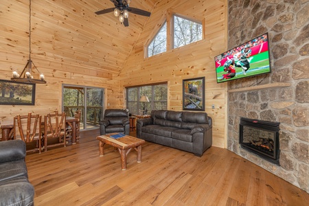 Living room and dining room with fireplace & tv at Bessy Bears Cabin, a 2 bedroom cabin rental located inGatlinburg