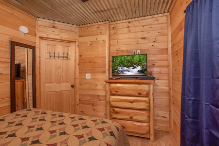 Bedroom with a chest of drawers and a TV at License to Chill, a 3 bedroom cabin rental located in Gatlinburg