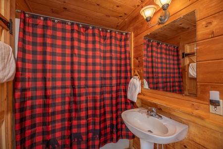 Bathroom with a tub and shower at Away From it All, a 1 bedroom cabin rental located in Pigeon Forge