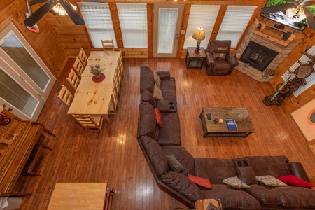 Looking down on the dining and living spaces from upstairs at Mountain Music, a 5 bedroom cabin rental located in Pigeon Forge