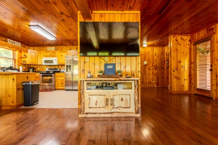 The kitchen and front door divided by amenity wall at 1 Crazy Cub, a 4 bedroom cabin rental located in Pigeon Forge